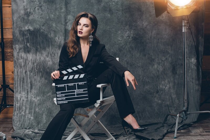 Young Beautiful Stylish Sexy Woman Cinema Backstage Holding Movie Clapper