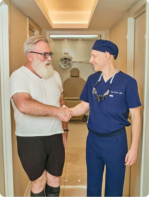 Dr. Gary Linkov shaking hands with a patient